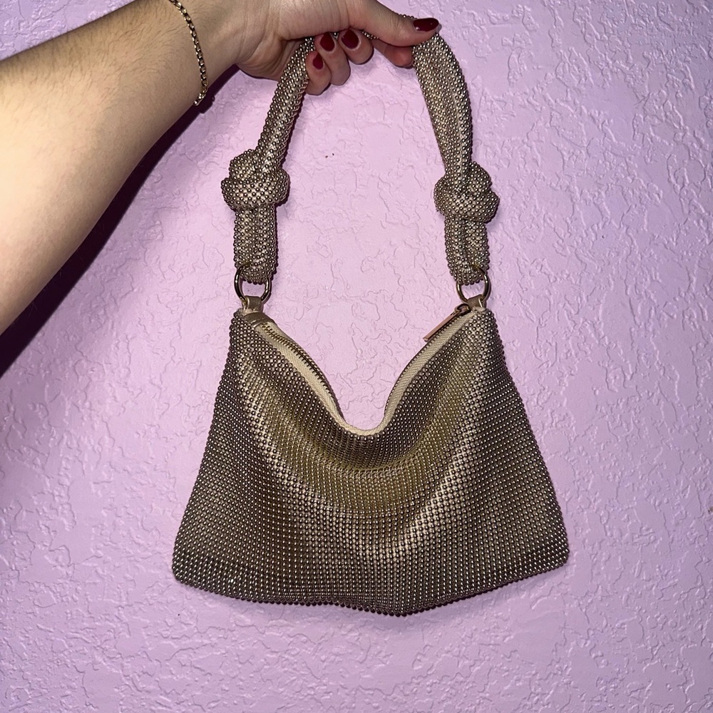 gold beaded shoulder bag with a unique knotted strap design